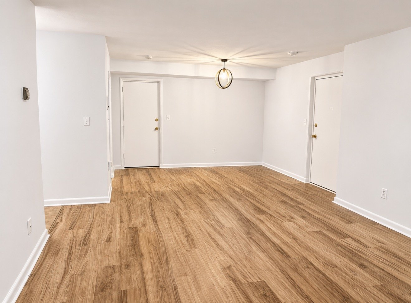 Apartment living area with freshly painted white walls, doors and trim